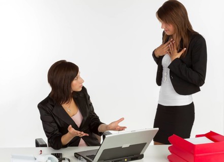 Two young women having a discussion in an office