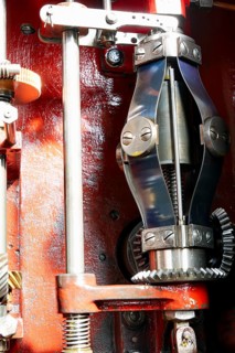 View into the open housing of a mechanical centrifugal governor for limiting the speed