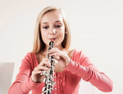 Teenage girl playing the oboe