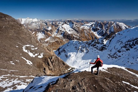 Mountain climber on the summit ridge while descending from Wilde Kreuzspitze Mountain in the Pfunderer Mountains