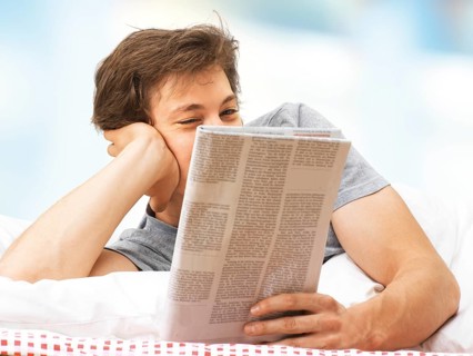 Young man lying in bed