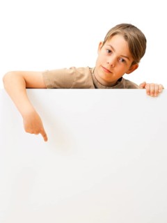 Schoolboy behind a white board