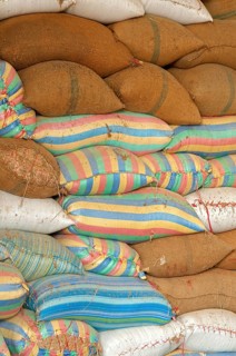 Plump bags of rice stacked in a rice warehouse