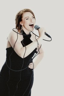Woman singing into a microphone