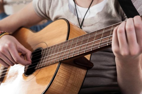 Teenage girl playing the guitar