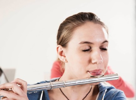 Teenage girl playing the flute