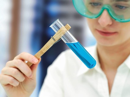 Scientist wearing a protective mask and holding a test tube