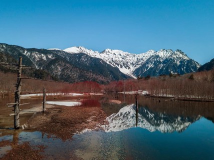 Snow-covered Japanese Alps reflected in Lake Taisho Pond