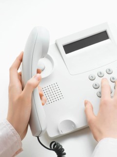 Woman making a call on a telephone