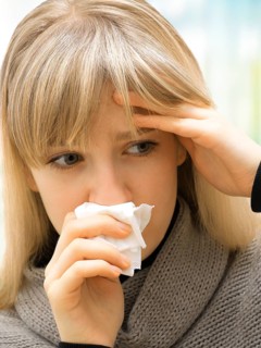 Young woman using a tissue