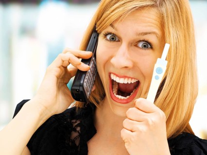 Woman holding a pregnancy test