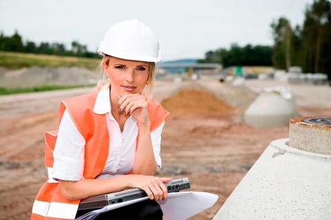 A young female constructor at building of a new motorway