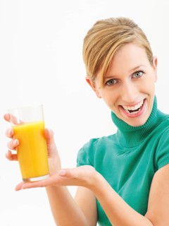 Young woman holding a glass of orange juice