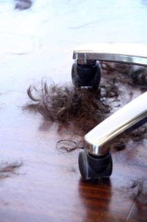 Hair lying on the floor next to a hairdresser's chair