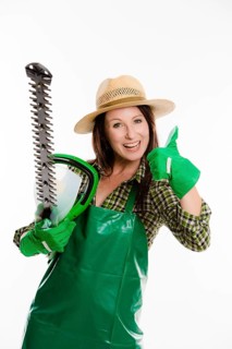 Female gardener holding a hedge trimmer