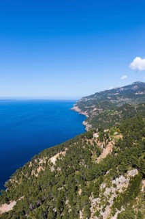 View of the cliffs with a remote house near Estellencs