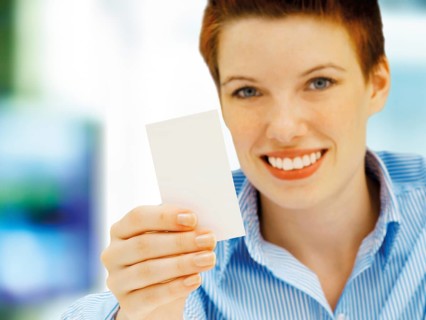 Businesswoman holding a blank business card