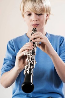 Teenage boy playing the oboe