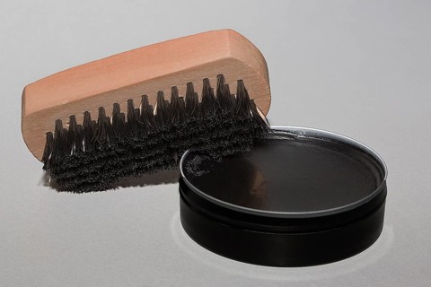Shoe brush with black shoe polish