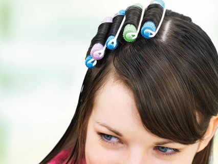 Young girl with curlers in her hair