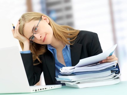 Businesswoman wearing glasses and using a laptop