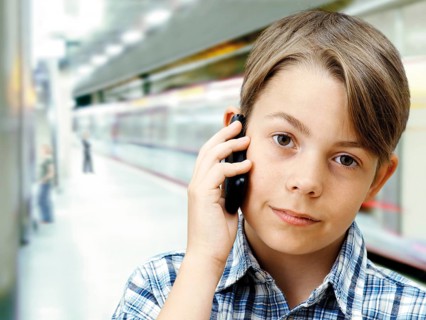 Teenager using a mobile phone in an underground railway station