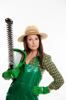 Female gardener holding a hedge trimmer