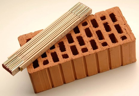 Folding rule lying on a red brick