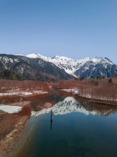 Snow-covered Japanese Alps reflected in Lake Taisho Pond