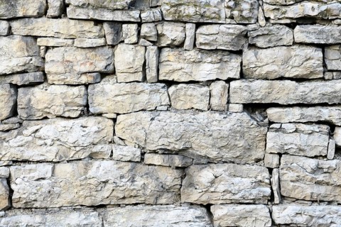 Old stone wall out of shell limestone