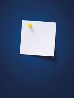 White note with a yellow pin on a blue wall