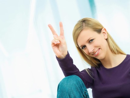 Young woman making a V sign with her hand