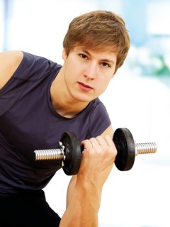 Young man doing strength training with a dumbbell
