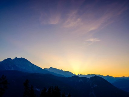 Mountain silhouettes reflected in an artificial mountain lake at sunset