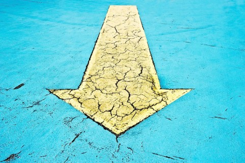 Yellow arrow on blue asphalt