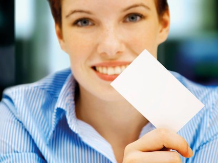 Businesswoman holding a blank business card