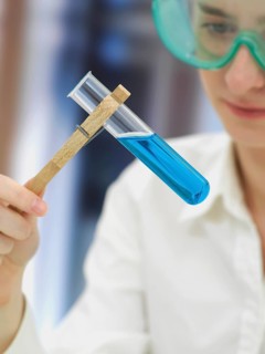 Scientist wearing a protective mask and holding a test tube