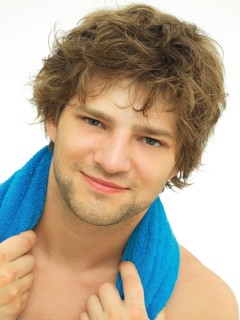 Young man with a blue towel wrapped around his shoulders