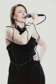 Woman singing into a microphone