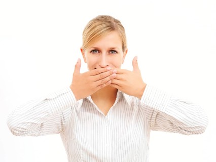 Young woman holding her hands in front of her mouth