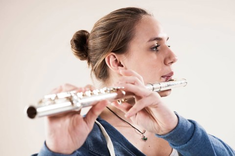 Teenage girl playing the flute