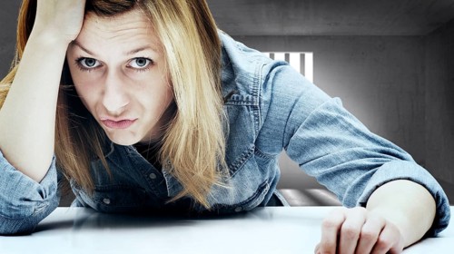 Young woman in a jail cell