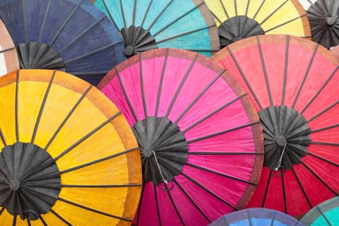 Multicoloured hand-made paper umbrellas or parasols on display at a market in Luang Prabang