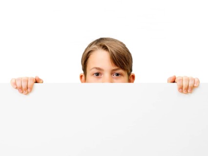 Schoolboy behind a white board