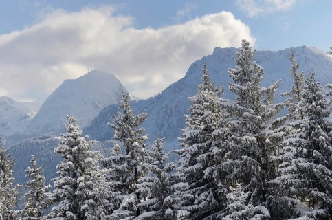 Snow clouds over winter mountain landscape
