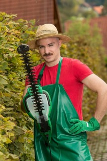 Gardener using a hedge trimmer