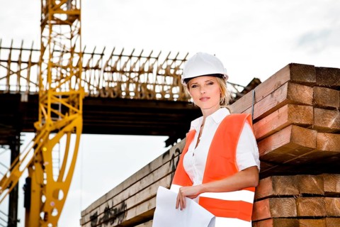 A young female constructor at building of a new motorway