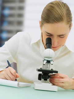 Scientist looking through a microscope