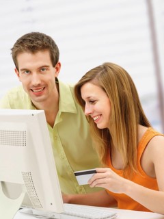 Young couple shopping online with a computer