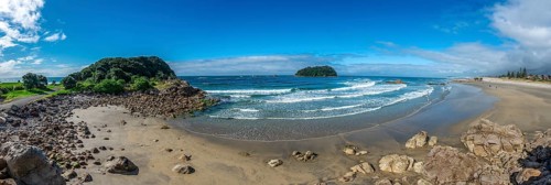 Sandy beach beach of Mount Manganui with peninsula Moturiki and island Motiti Island